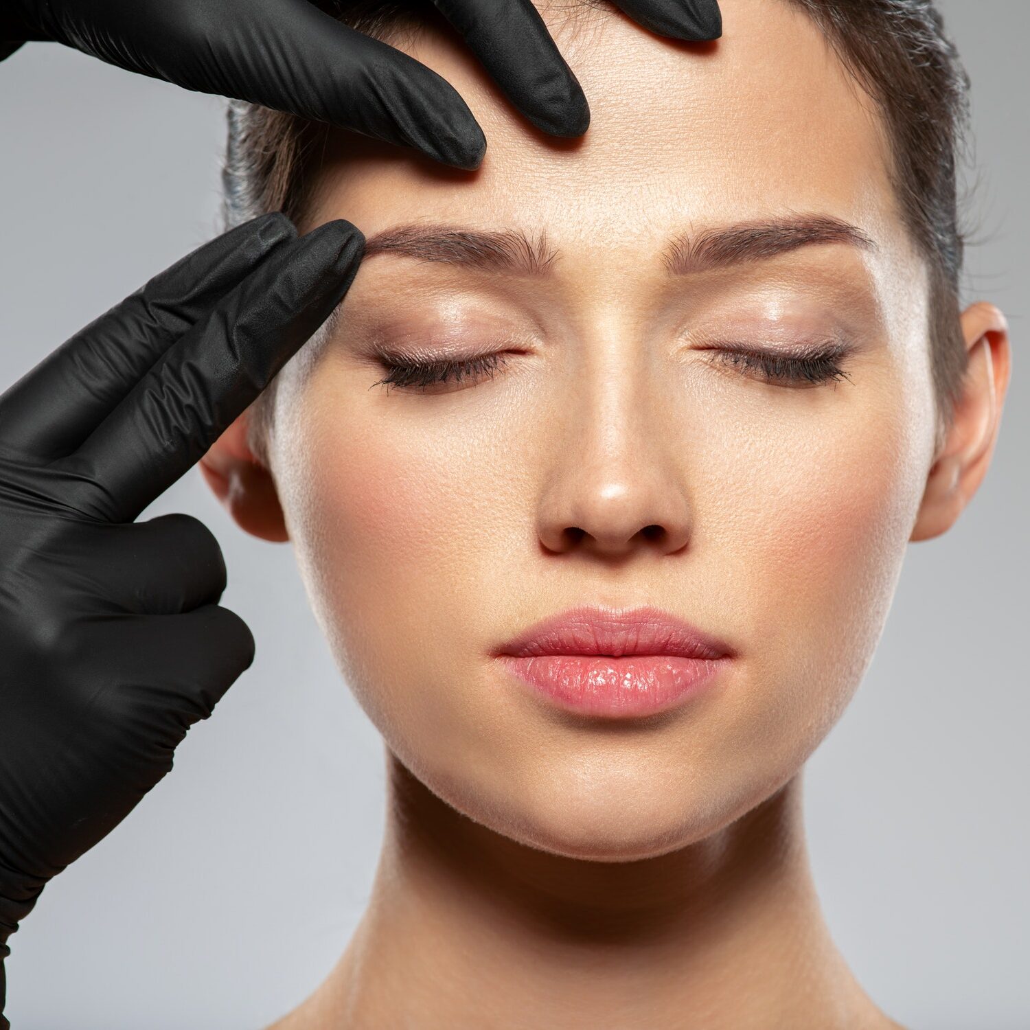 Face skin check before plastic surgery. Beautician touching woman face.